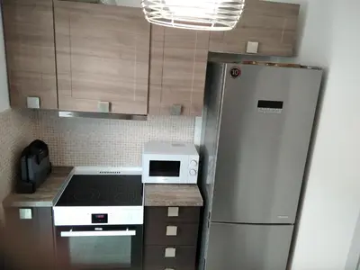 a kitchen with a refrigerator and a microwave at Blue Flag Glyfada Center in Athens