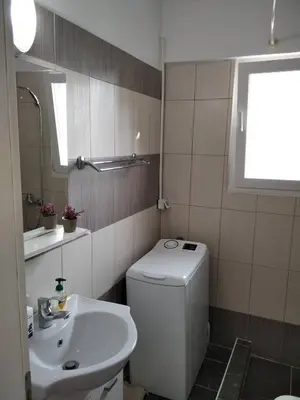 a bathroom with a white toilet and a sink at Blue Flag Glyfada Center in Athens