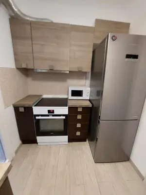 a kitchen with a stainless steel refrigerator and cabinets at Blue Flag Glyfada Center in Athens