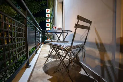 a chair and a table on a balcony at Royal Apartment in Athens