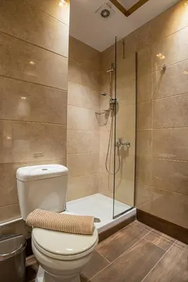 a bathroom with a toilet and a glass shower at Royal Apartment in Athens
