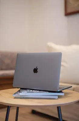 an apple laptop computer sitting on a wooden table at Royal Apartment in Athens