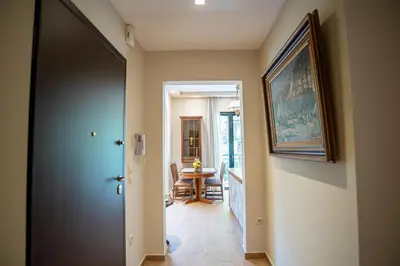 a hallway with a door leading to a dining room at Royal Apartment in Athens