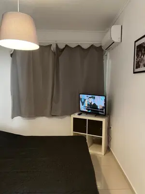 a bedroom with a bed and a television on a table at ALKYONI in Athens