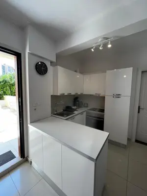 a kitchen with white cabinets and a white counter top at ALKYONI in Athens