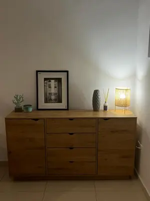 a wooden dresser with a picture and a lamp on it at ALKYONI in Athens