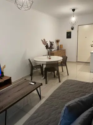 a living room with a table and a couch at ALKYONI in Athens