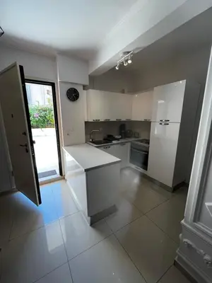 a kitchen with white appliances and a large window at ALKYONI in Athens