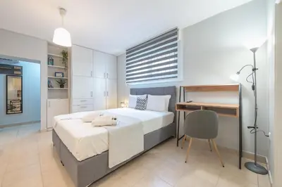 a bedroom with a bed and a desk in it at The Boutique Studio by CloudKeys in Athens