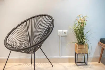 a black chair and a plant in a room at The Boutique Studio by CloudKeys in Athens