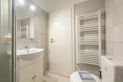 a white bathroom with a toilet and a sink at The Boutique Studio by CloudKeys in Athens