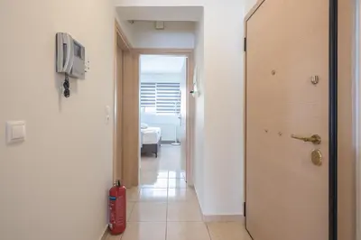 a hallway with a door leading to a room at Elegant Home with Balcony by CloudKeys in Athens