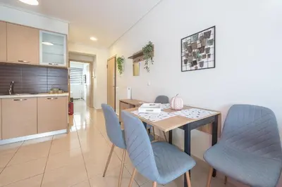 a kitchen and dining room with a table and chairs at Elegant Home with Balcony by CloudKeys in Athens