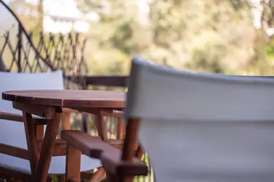 a wooden table and chairs on a patio at Athenian Serene City Escape in Athens