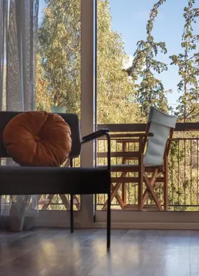 a balcony with a chair and a large window at Athenian Serene City Escape in Athens