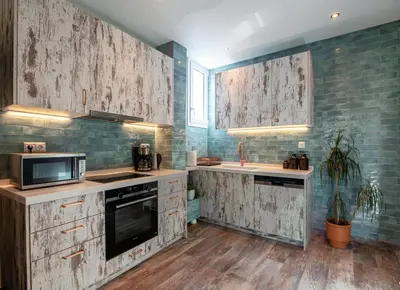 a kitchen with wooden counters and a microwave and appliances at Athenian Serene City Escape in Athens