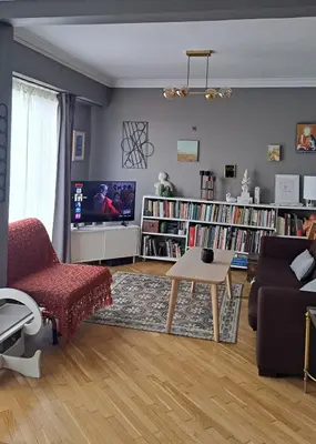a living room with a couch and a tv at Comfy penthouse in the center of Athens in Athens
