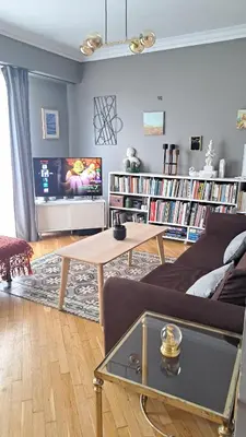 a living room with a couch and a table at Comfy penthouse in the center of Athens in Athens