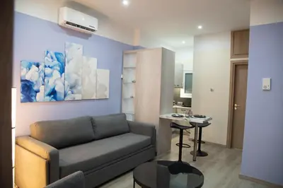 a living room with a couch and a table at Modern Apartment Downtown Athens in Athens