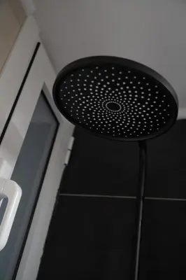a black stool sitting on top of a floor at Modern Apartment Downtown Athens in Athens