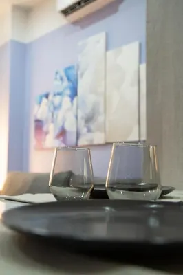 two wine glasses sitting on top of a table at Modern Apartment Downtown Athens in Athens