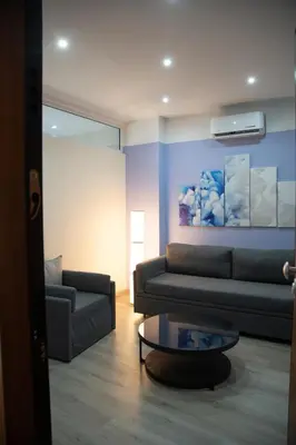 a living room with a couch and a coffee table at Modern Apartment Downtown Athens in Athens