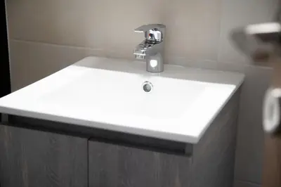 a white bathroom sink with a faucet on it at Modern Apartment Downtown Athens in Athens