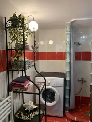 a washer and dryer in a bathroom with a washing machine at Cozy and Chic apartment in the Center, 5 min Subway in Athens