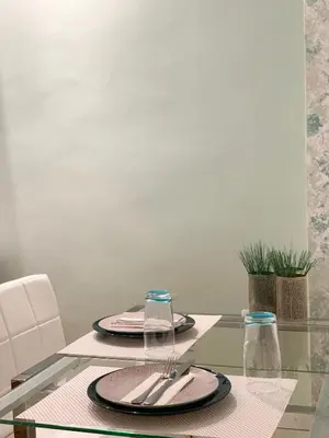 a glass table with two plates and silverware on it at Cozy and Chic apartment in the Center, 5 min Subway in Athens