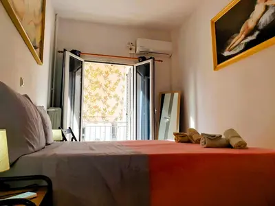 a bedroom with a bed and a window with shoes on it at Success's Apartment in Athens