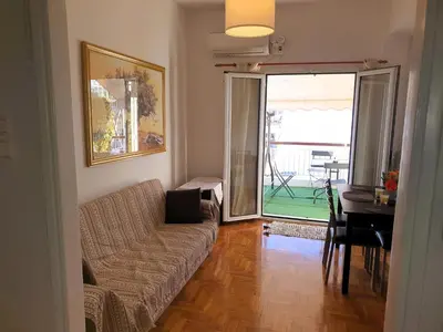 a living room with a couch and a table at Success's Apartment in Athens