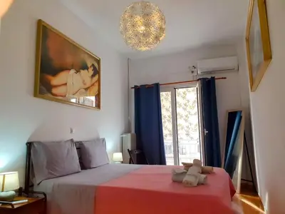 a bedroom with a bed with a teddy bear on it at Success's Apartment in Athens