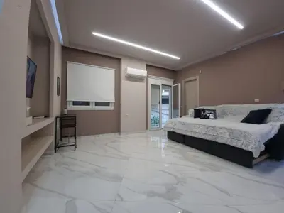 a bedroom with a bed and a large marble floor at CENTRAL in Athens