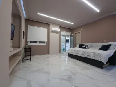 a bedroom with a bed and a large marble floor at CENTRAL in Athens