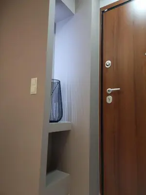 a bathroom with a wooden door and a shelf at CENTRAL in Athens