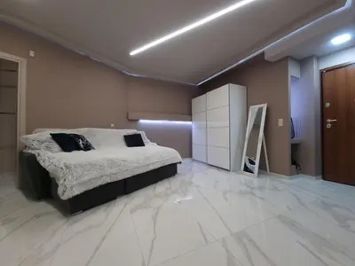 a bedroom with a bed in a room with marble floors at CENTRAL in Athens