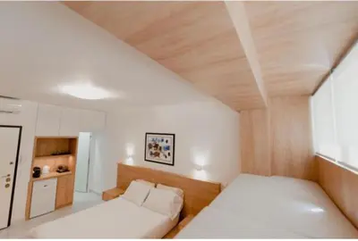 a bedroom with a white bed and a wooden ceiling at Luxury Studio in the heart of Kolonaki in Athens