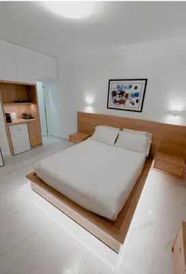 a bedroom with a large white bed in a room at Luxury Studio in the heart of Kolonaki in Athens