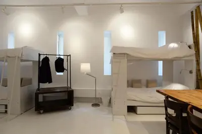 a room with two bunk beds and a table at Athens Soho Lofts - Super 8 in Athens