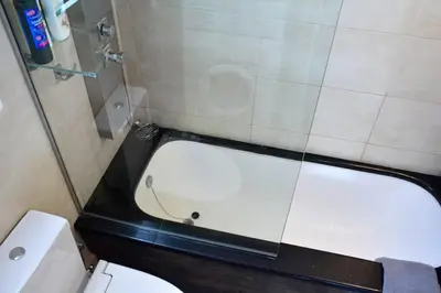 a bathroom with a toilet and a bath tub at Luxury at its best beach condo in Palaio Faliro in Athens