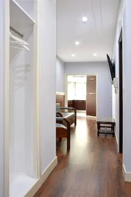a hallway with a living room with a couch and a table at Luxury at its best beach condo in Palaio Faliro in Athens