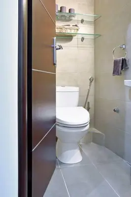 a bathroom with a white toilet and a shower at Luxury at its best beach condo in Palaio Faliro in Athens