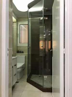 a bathroom with a glass shower and a toilet at Finer Things Flisvos Beach Condo in Palaio Faliro in Athens