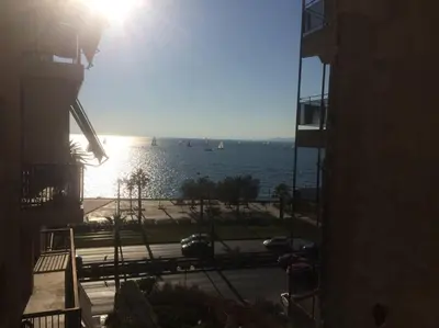 a view of the water from a building at Finer Things Flisvos Beach Condo in Palaio Faliro in Athens