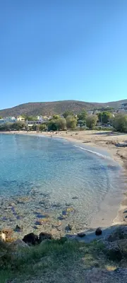 a beach with a group of people in the water at Sparkling dream in Saronida