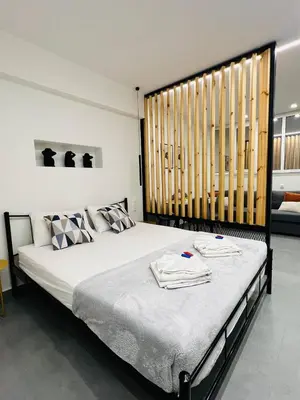 a bedroom with a large bed with towels on it at Cozy Corner Dialog Number 2 VIPGreece in Athens