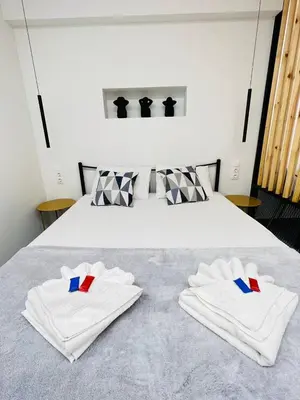 a bedroom with a bed with white towels on it at Cozy Corner Dialog Number 2 VIPGreece in Athens