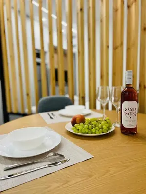 a table with a plate of grapes and a bottle of syrup at Cozy Corner Dialog Number 2 VIPGreece in Athens