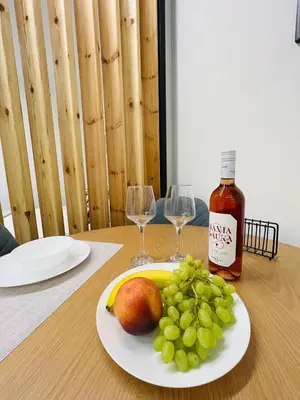 a plate of grapes and a bottle of wine on a table at Cozy Corner Dialog Number 2 VIPGreece in Athens