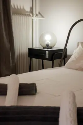 a bedroom with two beds and a table with a lamp at Adorable 2 bedroom apartment close to Ancient Athens city center in Athens